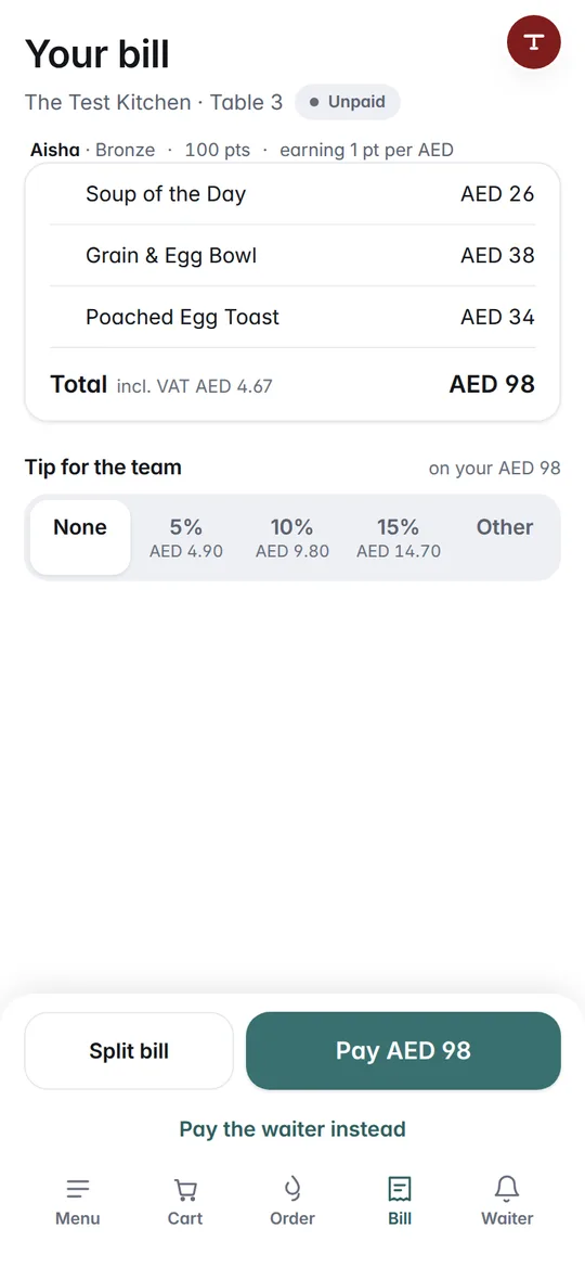The food served, Aisha's AED 98 bill for table 3 on her phone, with a tip to choose and Pay AED 98
